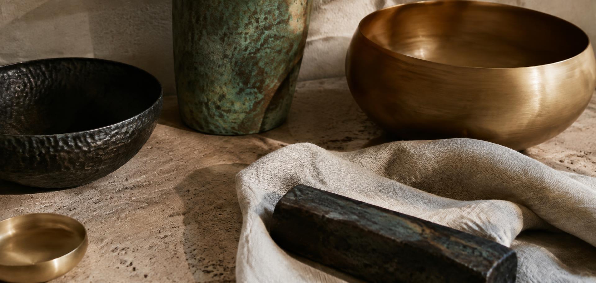 Hammered iron, verdigris bronze and honey brass on travertine